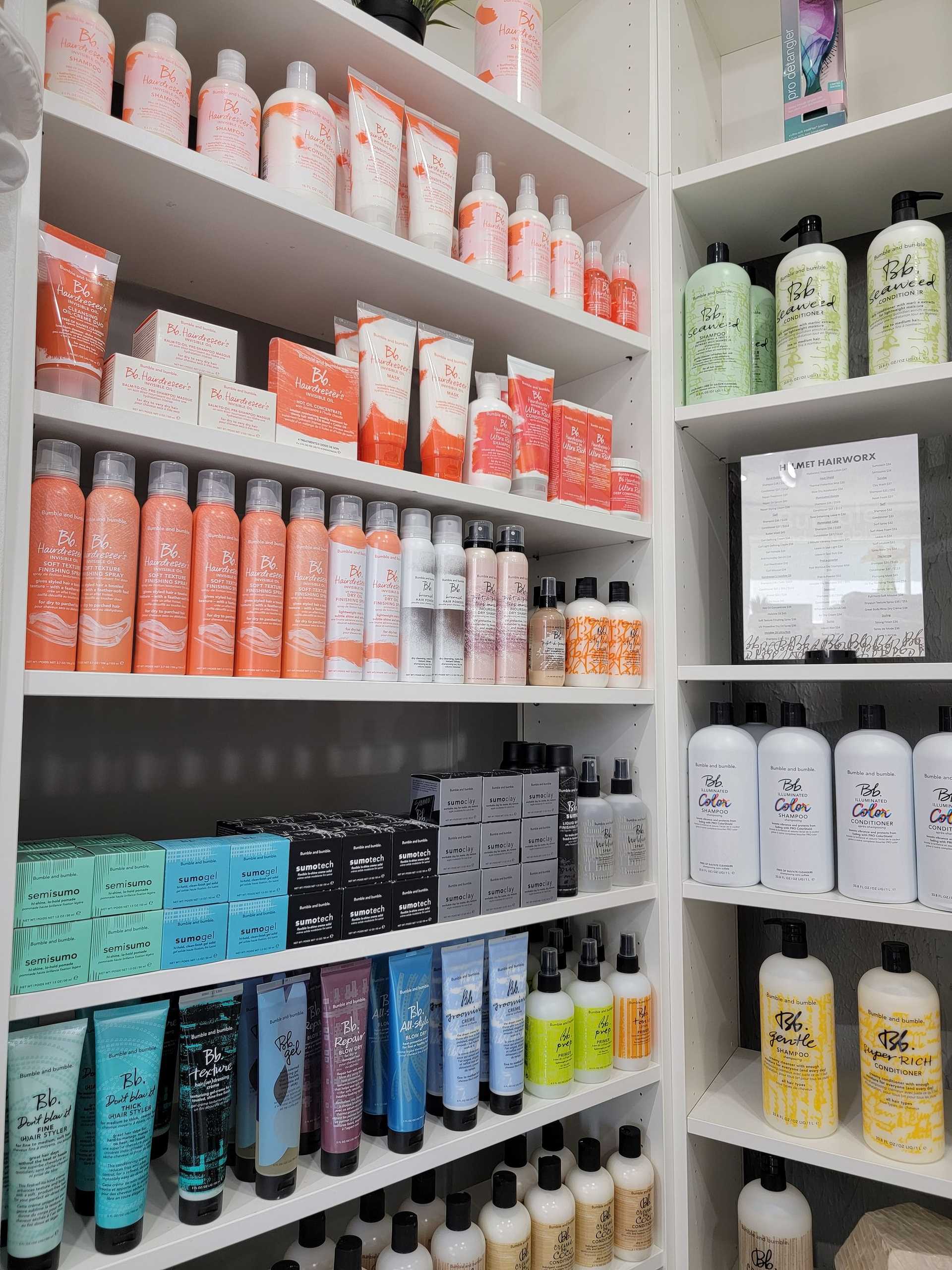 Shelves stocked with various hair care products in a salon.
